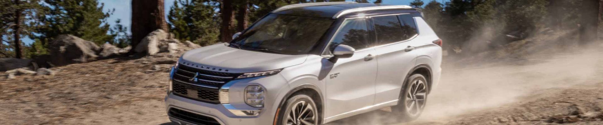 2023-mitsubishi-outlander-phev-white-driving-dirt